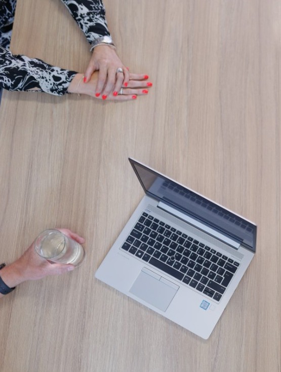 People in a meeting in front of a computer